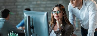 two-young-entrepreneurs-working-computer-reading-email-office_637285-1065