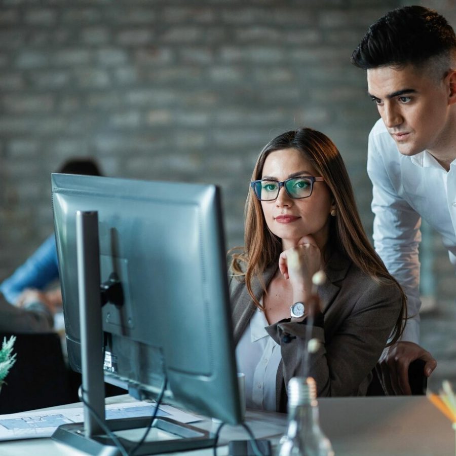 two-young-entrepreneurs-working-computer-reading-email-office_637285-1065